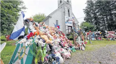  ?? SALTWIRE NETWORK ?? Items of condolence overflowed on the steps and yard in front of the old Portapique Church following the mass shooting in the community in April.