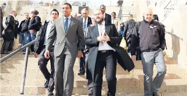  ?? FILE ?? Prime Minister Andrew Holness (left) walks alongside Rabbi Yaakov Raskin, co-director of Chabad of Jamaica, during a February 2017 visit to Israel.