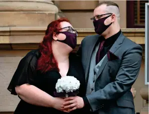  ?? AFP ?? wEDDINGS BEFORE ThE LOCkDOwN: Anna and Ulf Crothers have their photo taken after marrying at the Victorian Marriage Registry in Melbourne on wednesday, on the last day before weddings are banned in Melbourne for the next six weeks due to a new lockdown. —