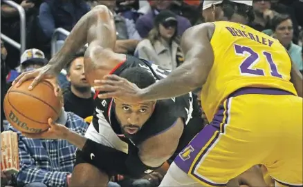  ?? PAUL GEORGE Photograph­s by Luis Sinco Los Angeles Times ?? of the Clippers looks for an opening against the defense of Lakers guard Patrick Beverley during the second quarter.