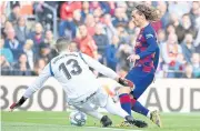  ?? AFP ?? Barcelona’s Antoine Griezmann scores against Getafe goalkeeper David Soria at the Nou Camp stadium.