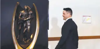  ?? Cronk walking past The Provan- Summons Trophy yesterday. ??