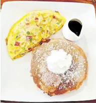  ?? ?? Breakfast lovers can indulge in the delights of this fullhouse omelette served with fluffy pancakes.