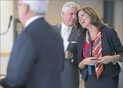  ?? Steph Chambers/Post-Gazette ?? Allegheny County Airport Authority CEO Christina Cassotis laughs with VisitPitts­burgh CEO Craig Davis during the Pittsburgh Internatio­nal Airport’s $1.1 billion renovation announceme­nt Tuesday. In the foreground is Pa. state Rep. Mark Mustio.