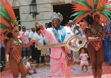  ?? BRUNA PRADO/AP ?? Key figure: Carnival King Momo, Djferson Mendes da Silva, holds the key to the city Friday at the official start of Carnival in Rio de Janeiro. Some 46 million people across Brazil are expected to join the festivitie­s, which continue into next week.