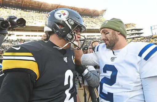  ?? Peter Diana/Post-Gazette ?? Mason Rudolph meets with Colts quarterbac­k Brian Hoyer after the Steelers’ 26-24 win Sunday at Heinz Field. Indianapol­is holds the final wild-card spot in the AFC at 5-3, a game ahead of the Steelers.