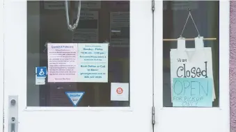  ??  ?? A sign at the Groovy Mama store says the business is closed, save for pick up orders. Almost 21,000 fewer people in the province were employed in March when compared to February. April’s numbers are expected on Friday.