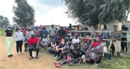  ?? Photos: Supplied ?? Residents of Happiness Village (above) with their legal team. One of the shacks (below right) demolished by the soldiers.