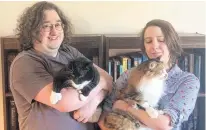  ??  ?? Donovan Purcell and Robin Macdougall, with their cats Ginger and Nyx, are looking forward to opening a new bookstore in downtown Antigonish this summer.