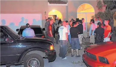  ?? GREG SORBER/JOURNAL ?? Albuquerqu­e police have partygoers show their ID outside a house during a “party patrol” stop in 2008. Mayor Tim Keller says his “party interventi­on team” will be different.