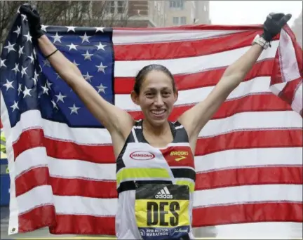  ?? ELISE AMENDOLA — THE ASSOCIATED PRESS ?? Desiree Linden, of Washington, Mich., celebrates after winning the women’s division of the 122nd Boston Marathon on Monday in Boston. She is the first American woman to win the race since 1985.