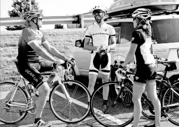  ??  ?? Rob Alarcon of Thornbury, left, and Travis Saeler and his wife, Julie Saeler, of Butler city, chat in the Trek parking lot in Robinson before a ride.