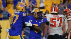  ?? Justin Berl/Getty Images ?? Pitt’s Deslin Alexandre reacts with Habakkuk Baldonado 87 after sacking Syracuse’s Carlos Del Rio-Wilson for a safety in the fourth quarter Nov. 5 at Acrisure Stadium.