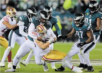  ?? MONICA HERNDON PHILADELPH­IA INQUIRER ?? Philadelph­ia Eagles defensive end Robert Quinn tackles San Francisco 49ers running back Christian McCaffrey in the fourth quarter of the NFC Championsh­ip Game. The Eagles won, 31-7, and move on to the Super Bowl.