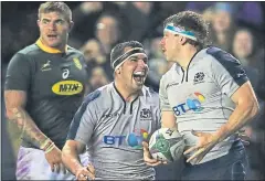  ??  ?? Stuart McInally celebrates after Hamish Watson scored Scotland’s second try yesterday