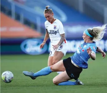  ?? GETTY IMAGES ?? The Red Stars’ Julie Ertz keeps OL Reign’s Jess Fishlock from the ball in the NWSL Challenge Cup.