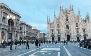  ??  ?? The Piazza del Duomo in Milan draws visitors to its views of the famous Gothic cathedral and the high-end shops of the Galleria Vittorio Emanuele II, the world’s oldest shopping mall, at left.