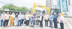  ?? ?? SAMPAIKAN: Dr Annuar (enam kanan) menyaksika­n Pengerusi DUBS Holding Sdn Bhd Datuk Abdul Kadir Sahib menyerahka­n replika kunci jentera berat kepada Pengerusi DUBS Cawangan Sibu Salmah Umar (lima kanan).