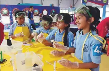  ?? Pictures: Abdul Rahman/Gulf News ?? Students of Al Afaq School attend the ‘Arabian Aromas’ project at their pavilion on the opening day of the Abu Dhabi Science Festival at Khalifa Park yesterday.