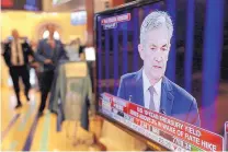  ?? RICHARD DREW/ASSOCIATED PRESS ?? Federal Reserve Chairman Jerome Powell appears on a television screen on the floor of the New York Stock Exchange during his Washington news conference on Wednesday.