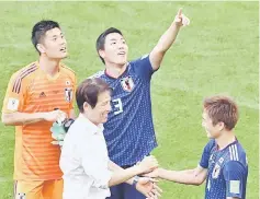  ?? — AFP photo ?? Japan coach Akira Nishino celebrates with players after the match.