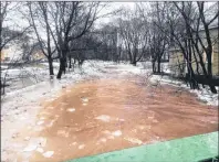  ?? THE CANADIAN RESS/HO-LAURIE BOUCHER ?? Antigonish Mayor Laurie Boucher provided this image of flooding in her town. People in a Nova Scotia community are closely watching water levels after a brook that snakes through town twice overflowed its banks and swamped a commercial area.