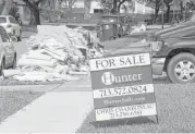  ?? Jon Shapley / Houston Chronicle ?? Debris is piled up outside a Meyerland home after the area flooded for the second time in 11 months.