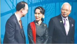  ?? AFP PHOTO ?? Myanmar State Counselor Aung San Suu Kyi ( center) speaks with the Department of Foreign Affairs ( DoF) Secretary Alan Peter Cayetano ( left) and Malaysian Prime Minister Najib Razak ( right) at the Asean- Australia special summit in Sydney on Thursday.