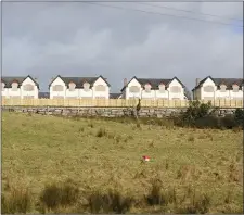  ??  ?? Housing scheme in Calry with its boarded up windows.