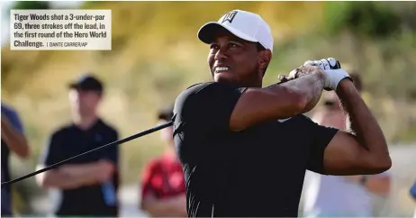  ??  ?? Tiger Woods shot a 3- under- par 69, three strokes off the lead, in the first round of the Hero World Challenge.
| DANTE CARRER/ AP