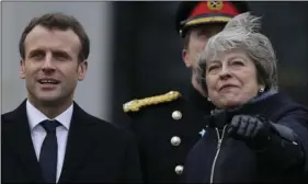  ??  ?? French President Emmanuel Macron and Britain’s Prime Minister Theresa May look at two Royal Air Force planes as they perform a fly past ahead of the start of an Anglo-French summit at the Royal Military College at Sandhurst, Camberley England on...