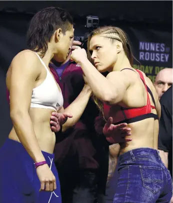  ?? (AP FOTO) ?? ALL EYES ON RONDA. Thirteen months after being on a bad end of a stunning knockout, Ronda Rousey (right) is determined to earn her redemption when she takes on UFC bantamweig­ht champion Amanda Nunes.