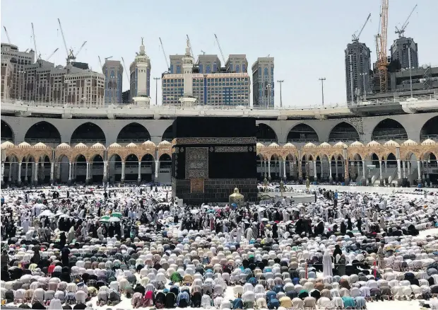  ?? KHALIL HAMRA / THE CANADIAN PRESS FILES ?? Muslims pray at the Grand Mosque in Mecca ahead of the hajj pilgrimage last year. Canadian Muslims considerin­g making the trip this year are feeling anxious about travelling to Saudi Arabia amid the recent tensions between the two countries and are asking travel agencies for refunds.