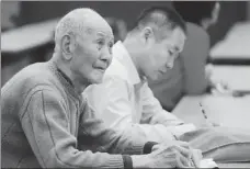  ??  ?? Above left: Chen Yu, an 82-year-old retiree from a local fertilizer factory, listens attentivel­y and takes notes at the reading club in 2019.