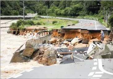  ?? STR/JIJI PRESS/AFP ?? A road collapsed due to heavy rain in Higashihir­oshima, Hiroshima prefecture on July 7.