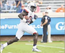  ?? Ryan M. Kelly / Getty Images ?? UConn running back Kevin Mensah scores a touchdown against Virginia last week in Charlottes­ville, Va.