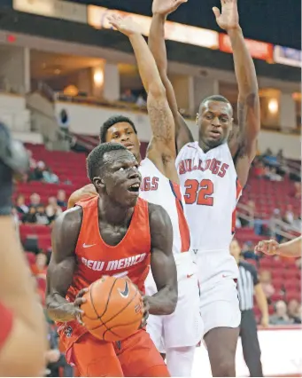  ?? CRAIG KOHLRUSS/FRESNO BEE VIA AP ?? New Mexico’s Makuach Maluach, left, will be anchoring the Lobos this coming season.