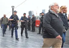  ?? ANDY RAIN, EUROPEAN PRESSPHOTO AGENCY ?? Police patrol Monday near a vigil for victims of Saturday night’s deadly terrorism attack on London Bridge.