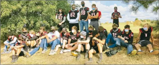  ?? (NWA Democrat-Gazette/Susan Holland) ?? Members of the Gravette High School football team gather to watch the stream of vehicles passing by Friday during the 2020 homecoming parade. The Lions met the Huntsville Eagles in football action that evening but unfortunat­ely lost, 28-26.