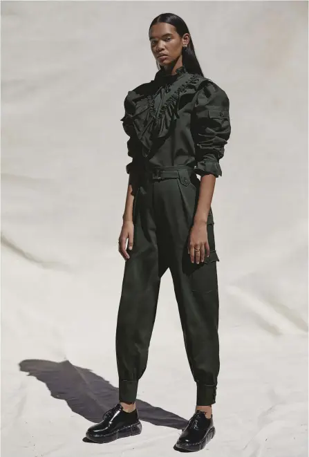  ??  ?? A paean to the super-women of the world, the strength of MILITARY PIECES, as only Miuccia can do them, reminds us that a wardrobe bolstered by utility makes us feel ever at the ready. Miu Miu shirt, $1,350, and pants with belt, $1,740. Bulgari earrings, $5,850 and 4,000, and rings, $1,720 and $3,260. Prada shoes, $1,270.