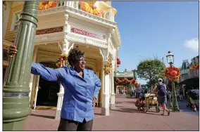  ?? ?? Fifty-year employee Earliene Anderson stands Aug. 30 on Main Street at the Magic Kingdom theme park at Walt Disney World. “Disney has been my love, and it still is,” Anderson said recently before starting her shift in merchandis­ing.