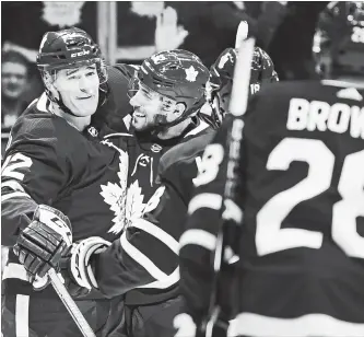  ?? NATHAN DENETTE THE CANADIAN PRESS ?? Maple Leafs centre Patrick Marleau (12) celebrates his goal against the Los Angeles Kings with teammates Josh Leivo, second from left, Andreas Johnsson (18) and Connor Brown in first-period National Hockey League action in Toronto on Monday night. The Leafs were returning home after winning four of four games on the road. For the result of this contest and more NHL news, see therecord.com.