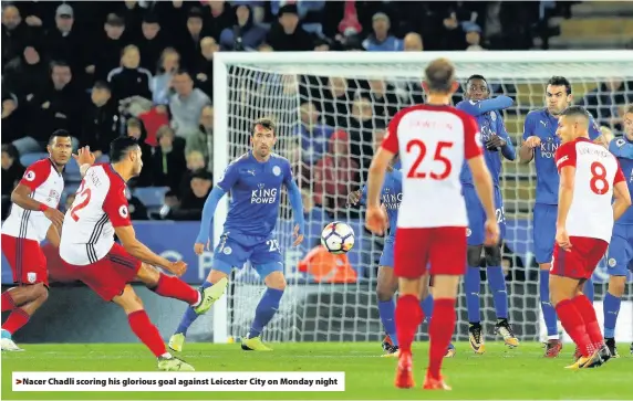  ??  ?? > Nacer Chadli scoring his glorious goal against Leicester City on Monday night