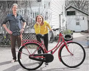  ?? THREE SISTERS LANDSCAPIN­G ?? Tim Haines, left and Carlotta James with bike Electric Lady. Three Sisters Natural Landscapes has a goal of making climate-friendly choices for their business and for their clients.