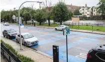  ?? ANTHONY VAZQUEZ/SUN-TIMES PHOTOS ?? A giant blue Black Lives Matter mural (above, left) was painted onto the pavement at 70th Street and Jeffery Boulevard last year, while another (above, right) done in Oak Park on Scoville Avenue near Lake Street was later vandalized to read “All Lives Matter.” Crews in the near west suburb were dispatched to restore the original wording.