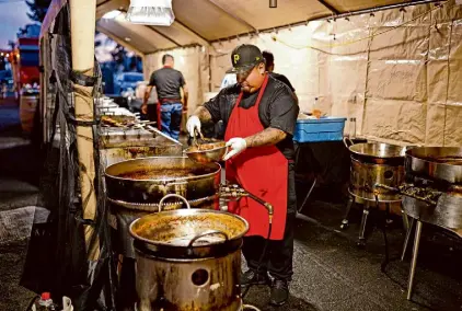  ?? ?? Alex Ceja, shown preparing the pork, has taken up the family profession.