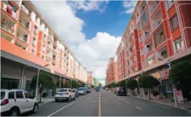  ??  ?? The relocation site for poverty-stricken households in Caiguan Town, Anshun City, Guizhou. To make employment easier, buildings were constructe­d with two stories: The first floor is for shops and workshops and the second for residences. Residents can work on the first floor without worrying about taking care of the family.