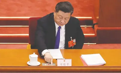  ?? NICOLAS ASFOURI/AFP/GETTY IMAGES ?? China’s President Xi Jinping votes in May on a proposal to draft a security law on Hong Kong.