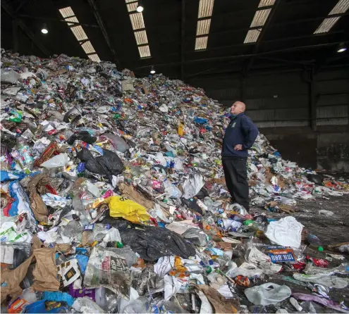  ?? ?? A copy of the Glasgow Times in the recycling, and above, supervisor Andy Gordon with a pile of items that people have put in their blue bins