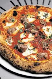  ?? James Nielsen / Houston Chronicle ?? Sweet Sausage pizza